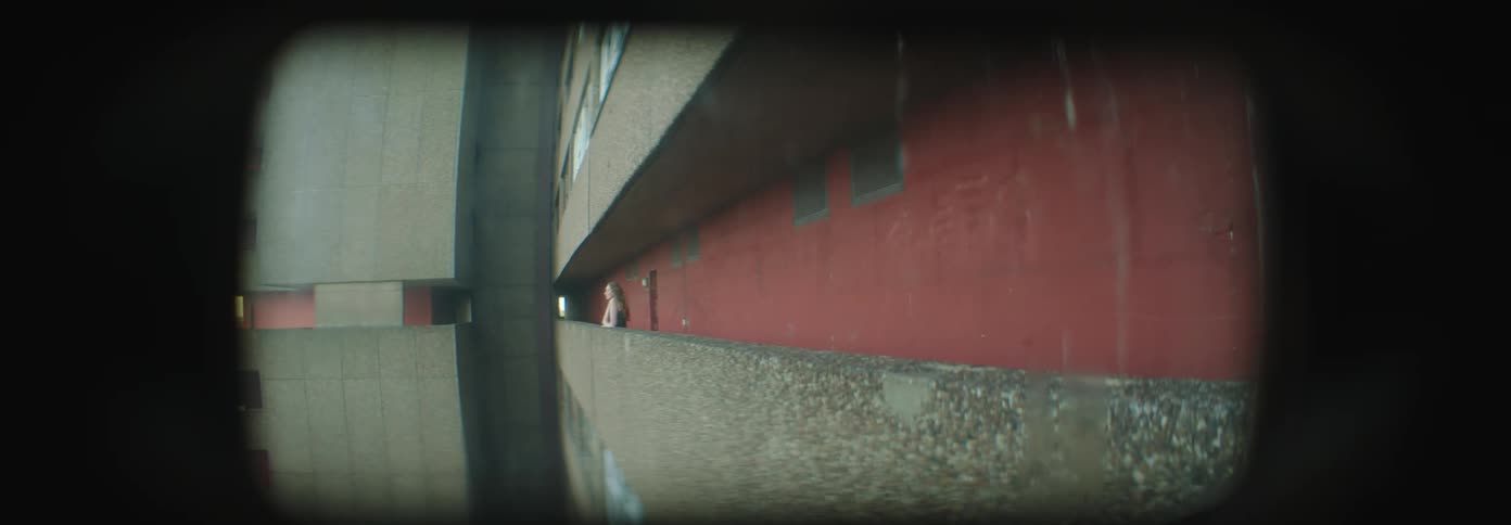 View of a woman walking in a corridor of a building stopping and observing