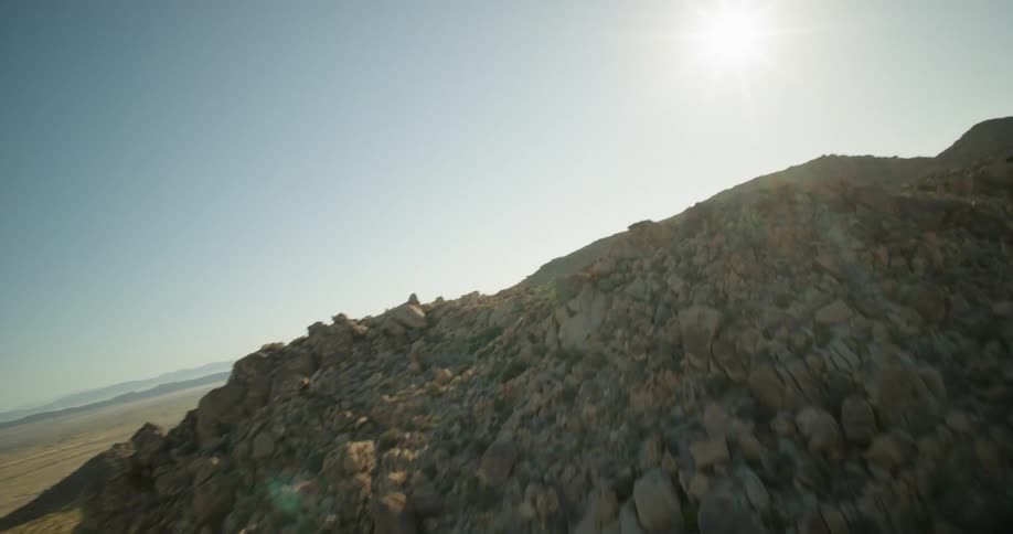 Piles of rubble and debris in the wilderness near a small city on a sunny day in a hilly landscape