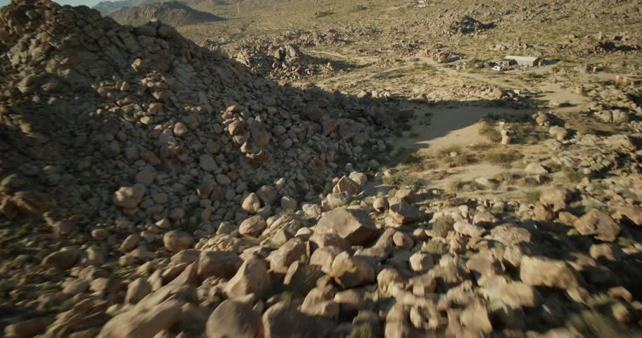 The hills in the desert are covered in stones