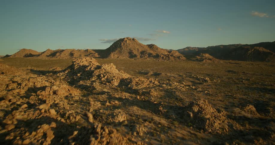 Aerial panorama of mountains with rocky formations under a morning sky