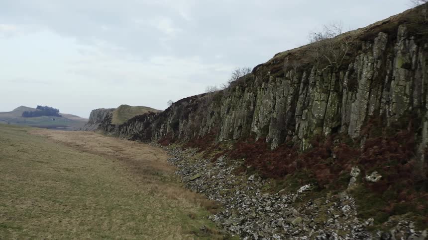 View of an outdoor and natural environment with grassland and a coastline