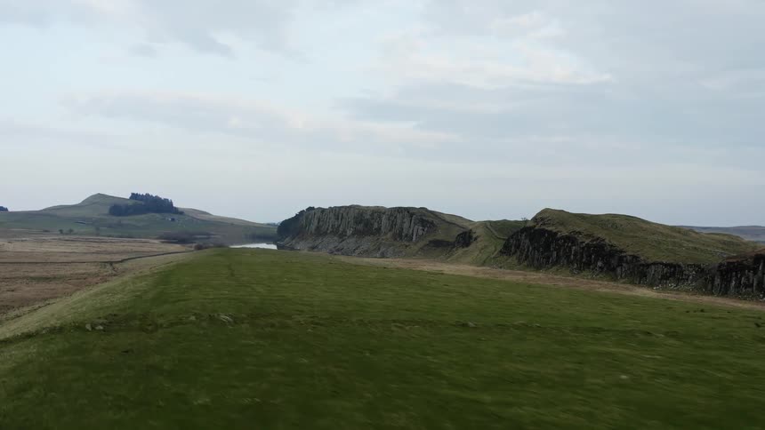View of a grassland under a cloudy sky
