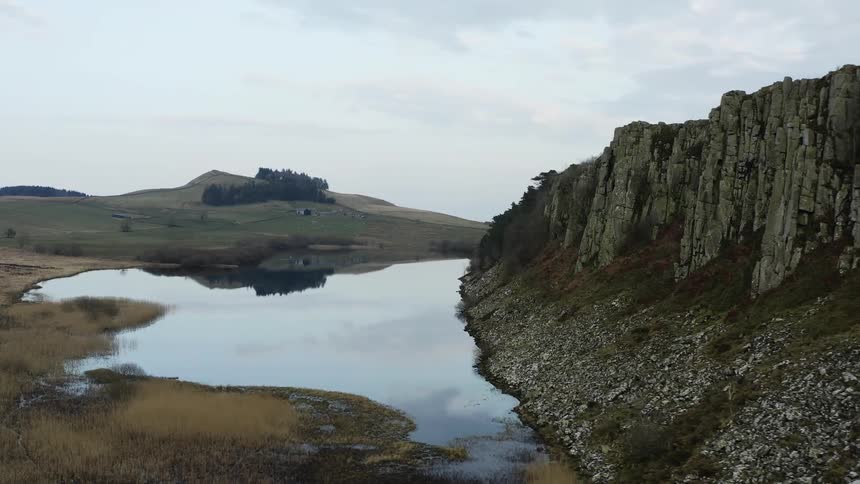 Panorama of a natural environment with a lake mountains and a cloudy day