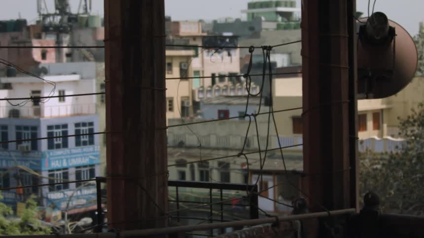 Beyond this balcony are rows of buildings