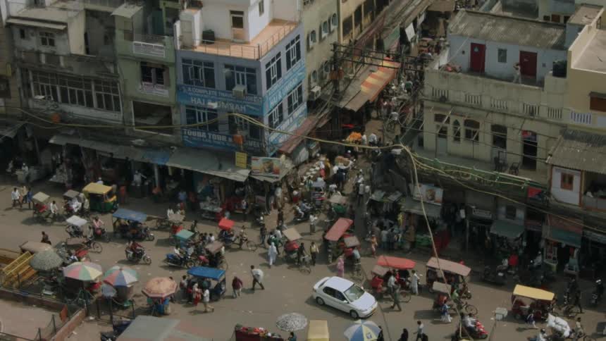 A busy city street is filled with people and vehicles