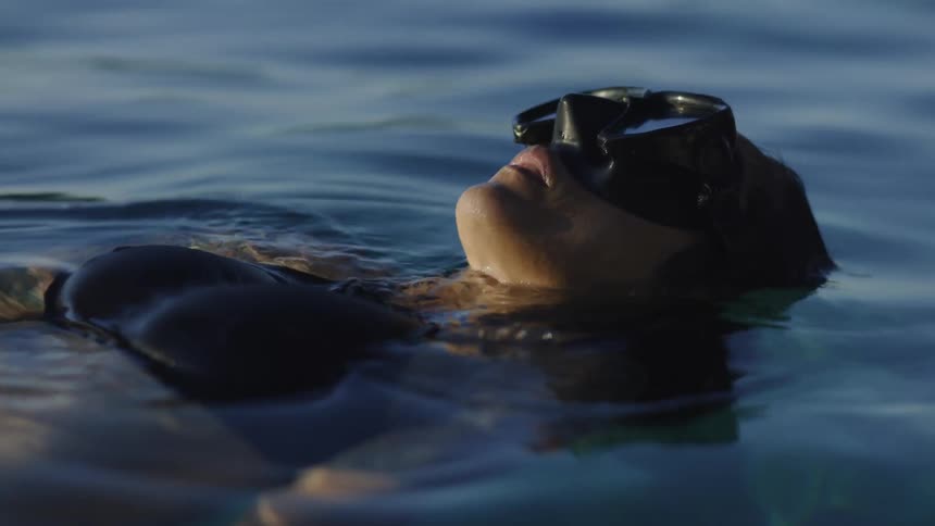 A woman floating in the water during the day