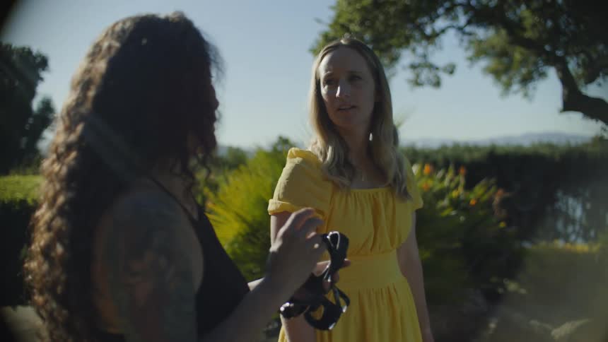 Woman carrying swimming goggles talks to a friend