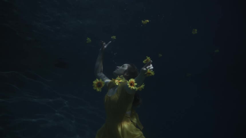 A woman is floating underwater