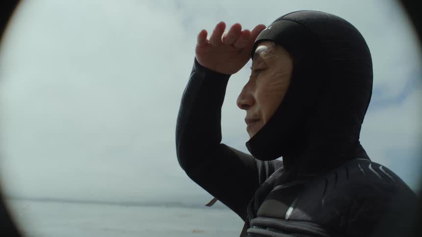 A diver looking out to the horizon from a boat