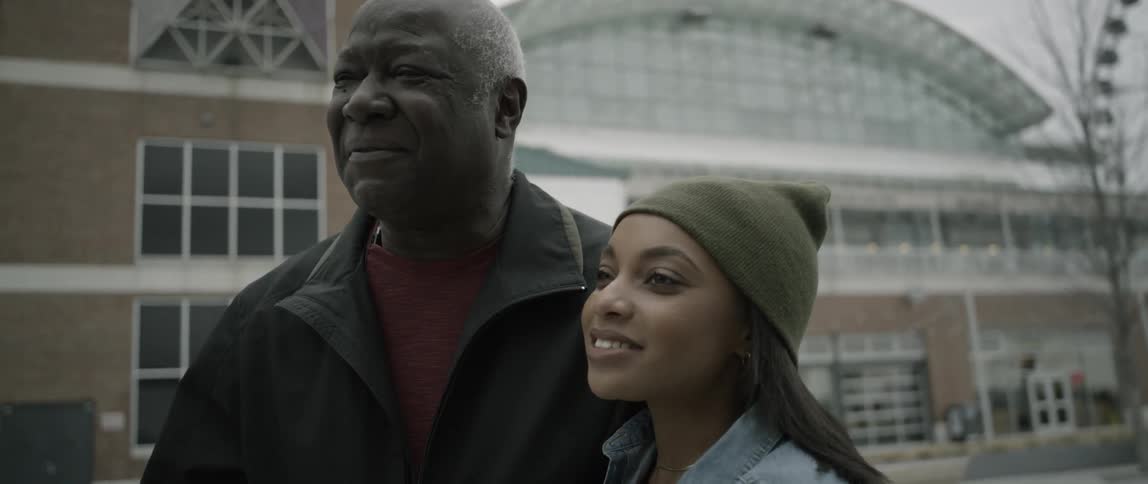 A woman and man talk outside on a cloudy day