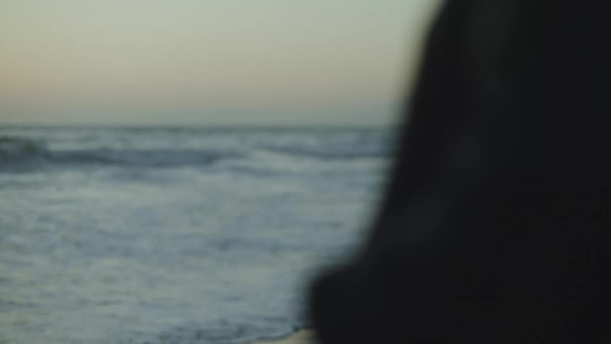 Profile of a woman looking at the ocean