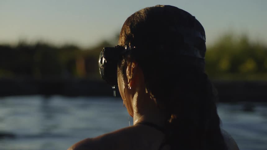 A swimmer coming out of the pool to watch the sunset