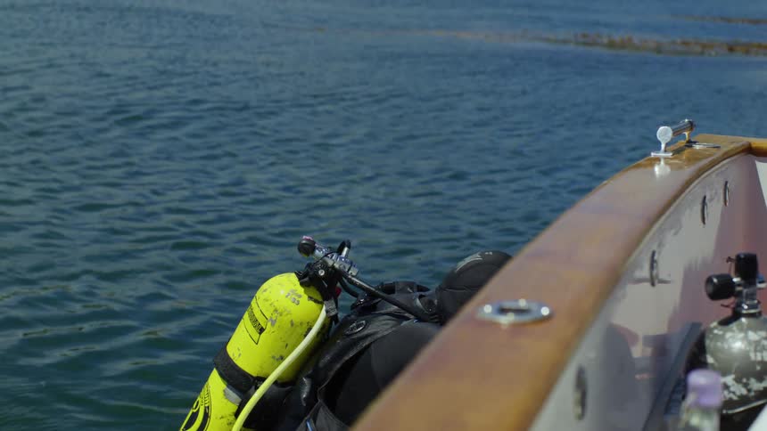 Diver climbs back up to the boat from the ocean at midday
