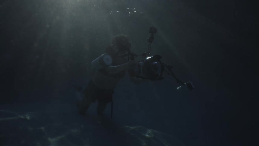 Swimmer taking pictures underwater