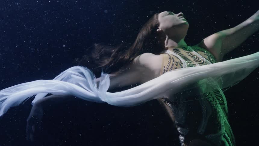 Artistic swimmer dances towards the surface