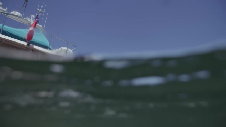Scuba diver jumps into the ocean from a boat