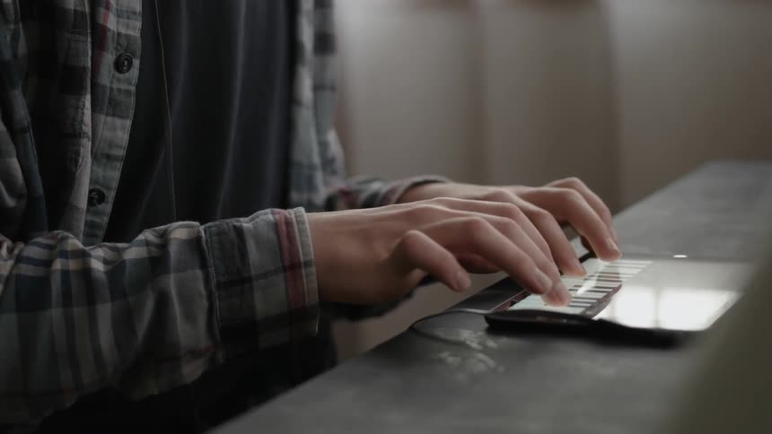 A man is playing a keyboard on a tablet