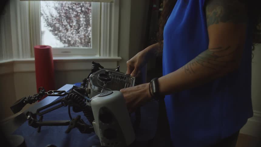 A woman setting up an underwater camera housing