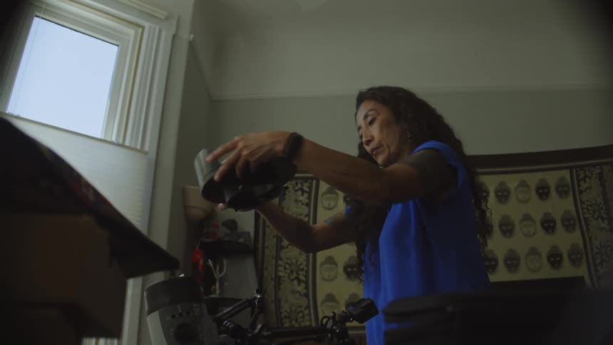 A woman puts together a camera housing