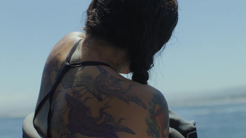 A diver trying to pull of her diving suit
