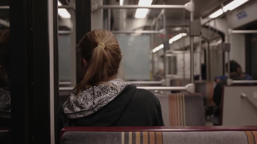 A woman is riding the bus