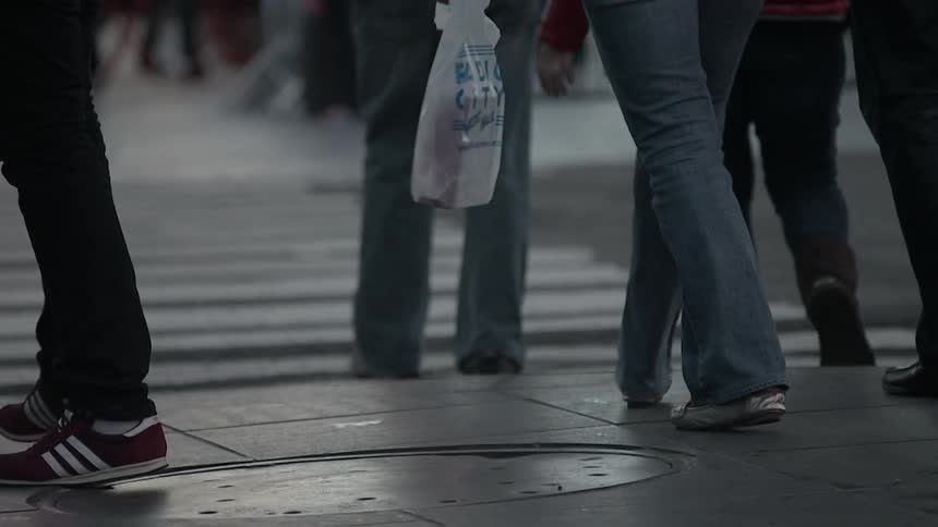 People walking along a city sidewalk