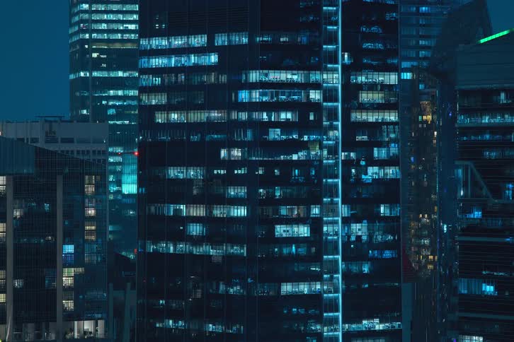 Office buildings with blue lights illuminating at night