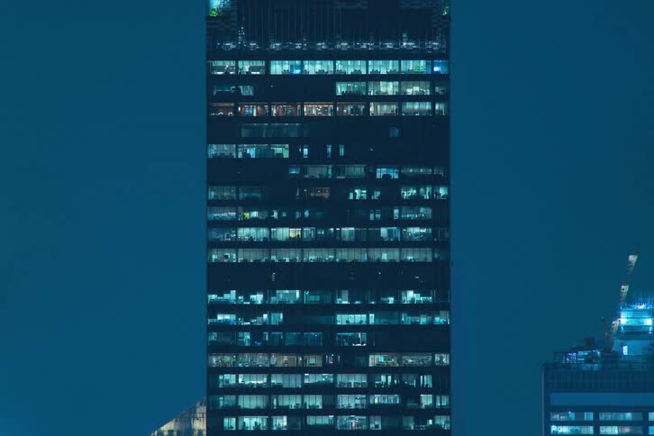 Exterior view of a tall office buildings in the city at night