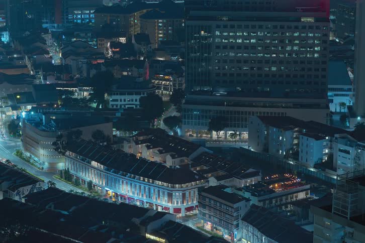 An aerial night view of a city with fast flashing lights
