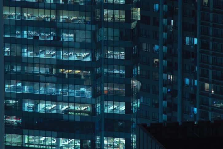 Time lapse of lights going on and off on an apartment building