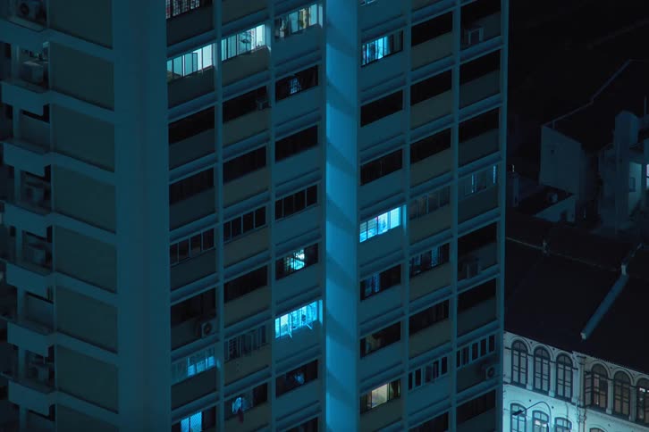 An apartment with flashing lights in the city at night