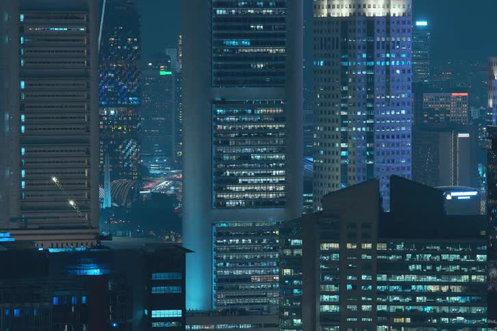 Panorama of skyscrapers with lights turning on at night in time lapse