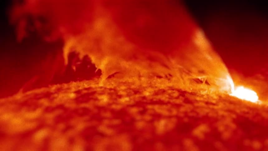 Extreme closeup of red smoke emanating from a bright and abstract hole