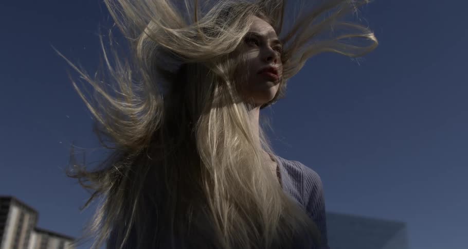A sow motion of wind blowing a ladys hair