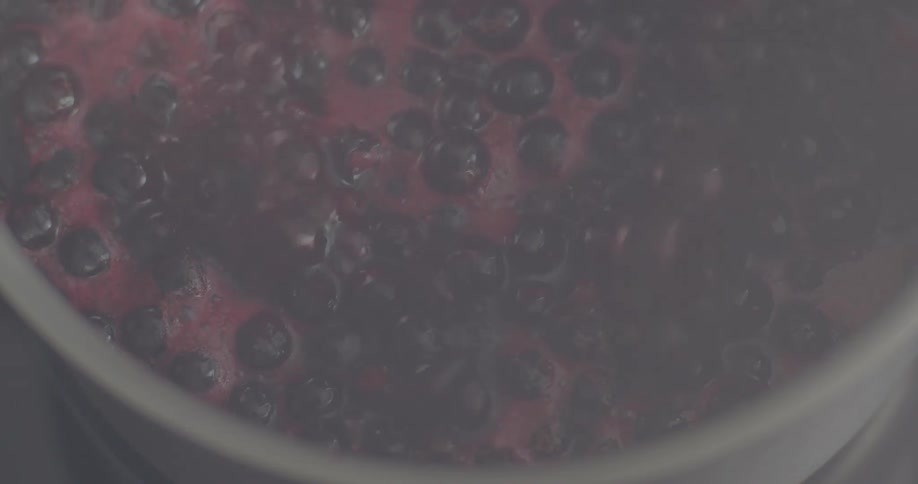 Purple liquid boiling in the pot with bubbles
