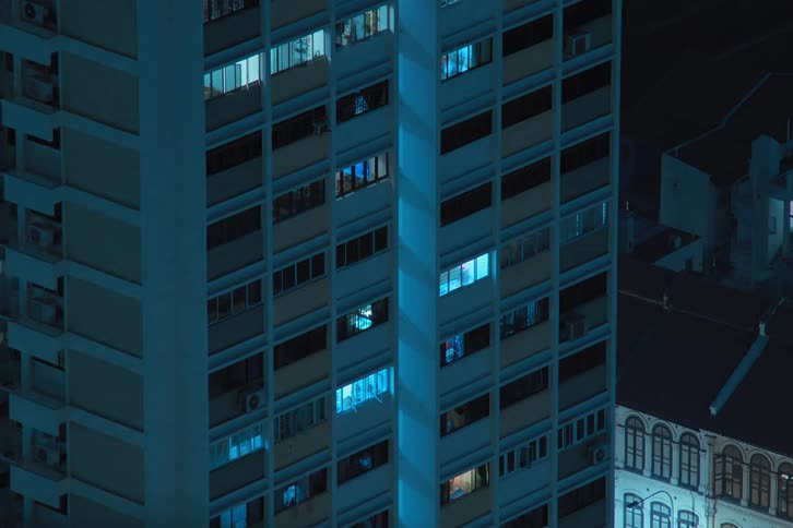 A yellow building with flashing light at night in the city