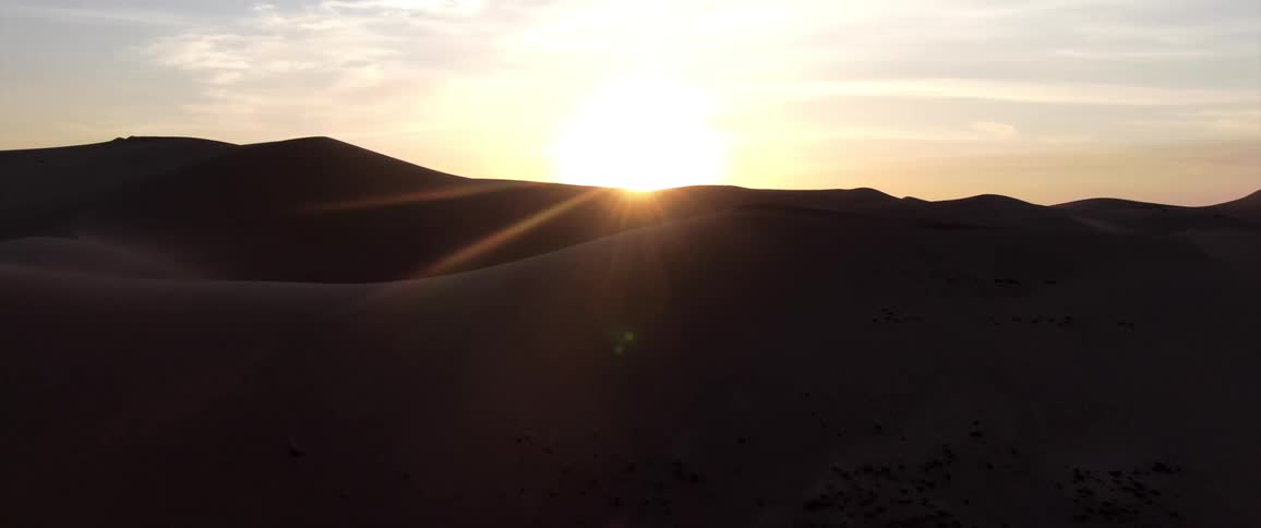 Aerial panorama of dunes in a desert under a morning sky