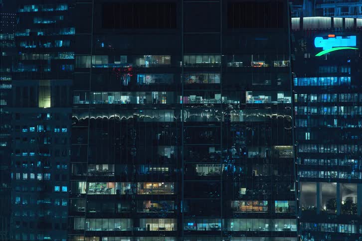 View of a skyscraper at night in time lapse with lights turning on and off