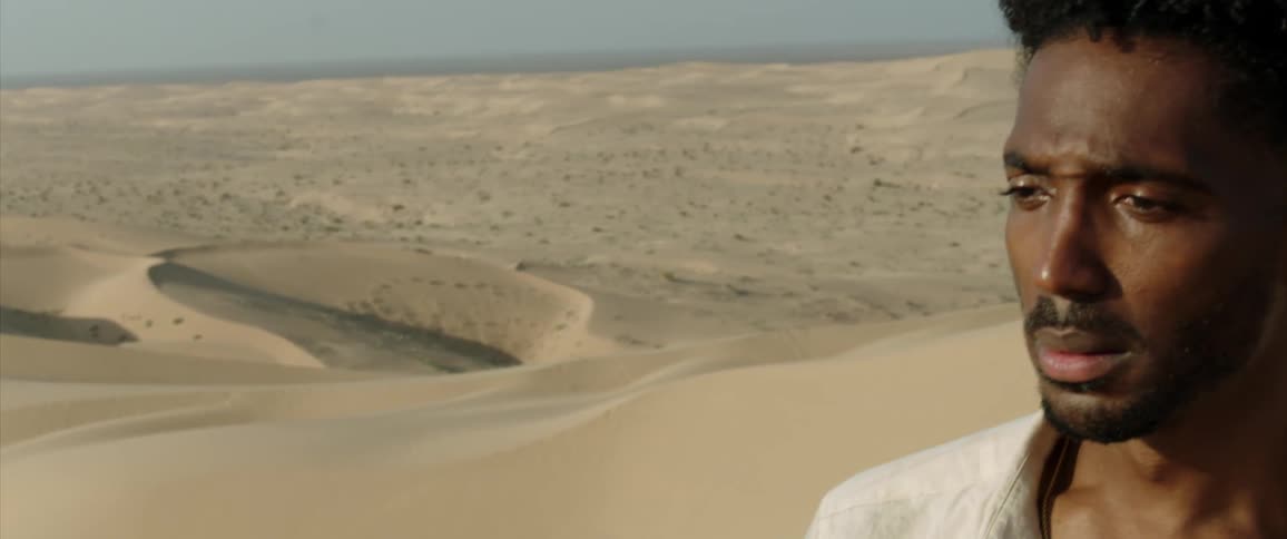 Portrait of a man walking through the dunes