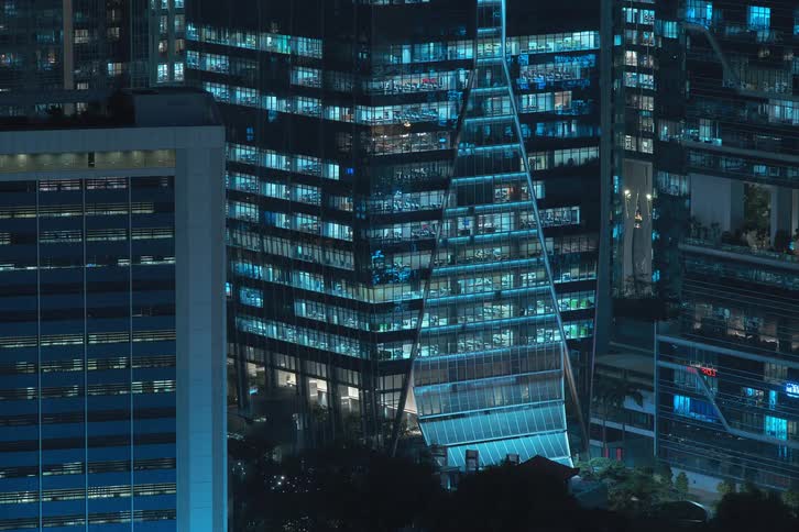 Buildings in a big city are lit up at night and turn on