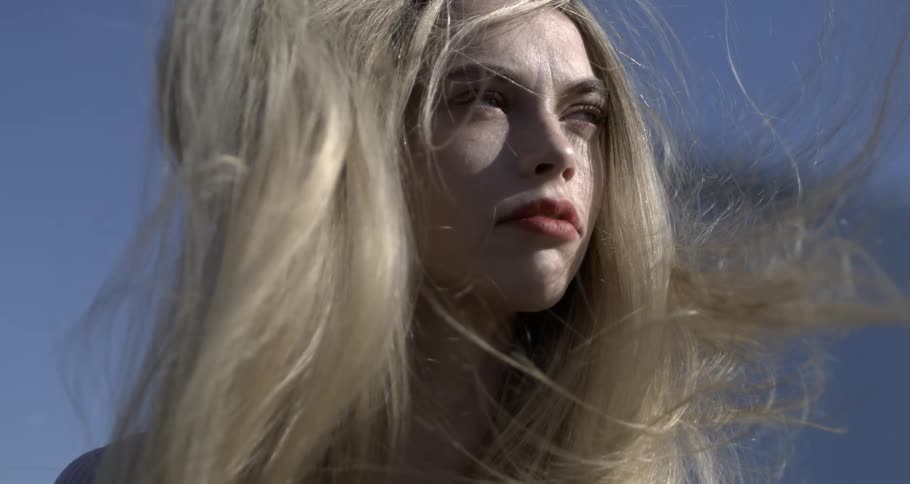 Closeup of a womans blonde hair blowing in the wind