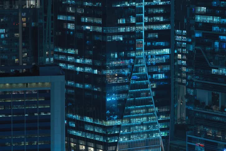 Blue light from buildings flashing at night in the city