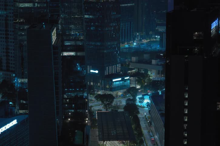 View of residential skyscrapers in a nocturnal metropolis with lights turning off in timelapse