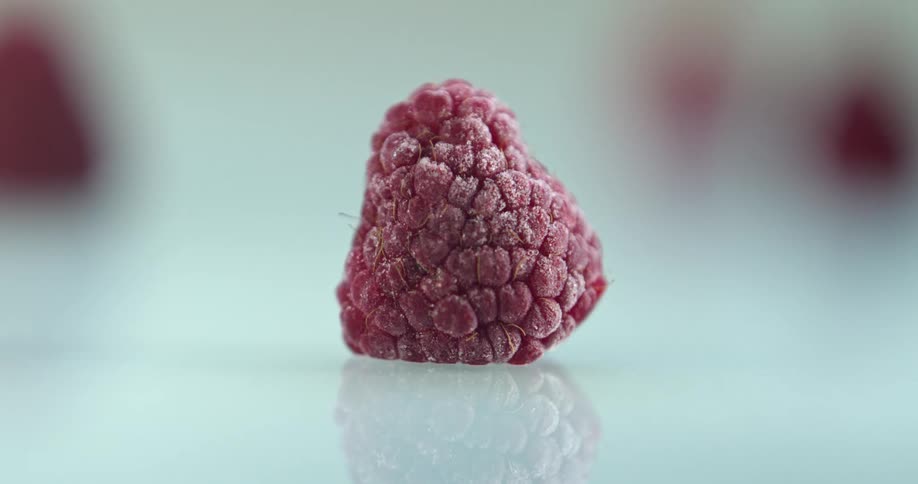 A time lapse of a raspberry shows it progressively freezing