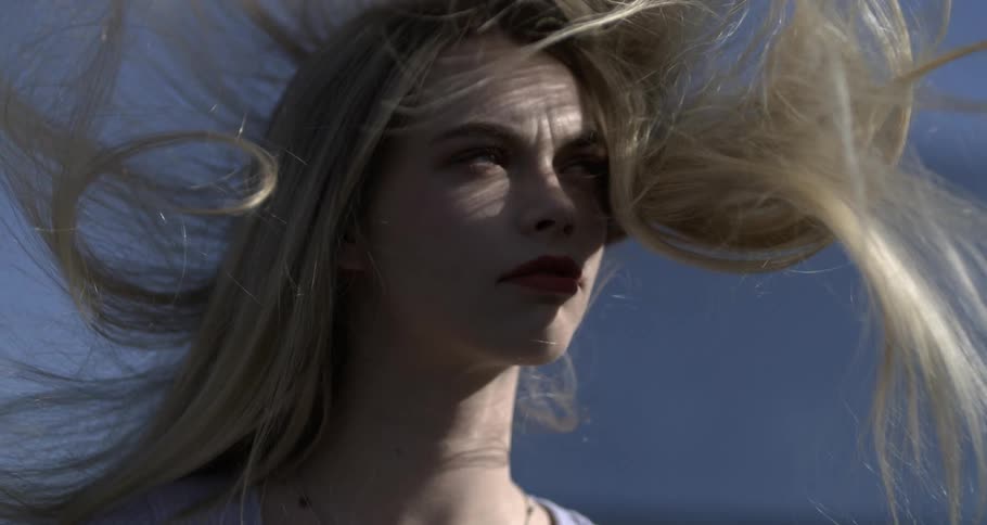 Portrait of a young woman with her hair flying