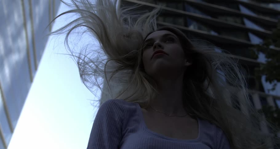 A clip of a blond waving her hair