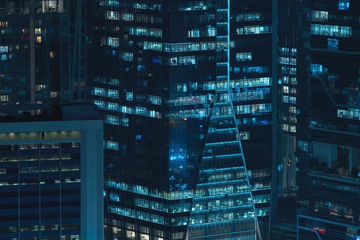 Commercial buildings with mirrored windows that reflect the city light