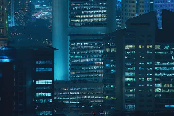 Buildings and city lights in a metropolitan area during night time