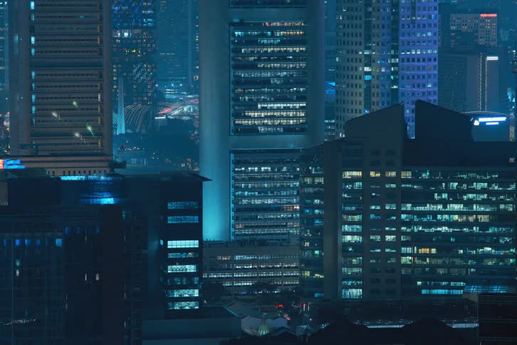 A time lapse of a tower blocks lights turning on and off during the night