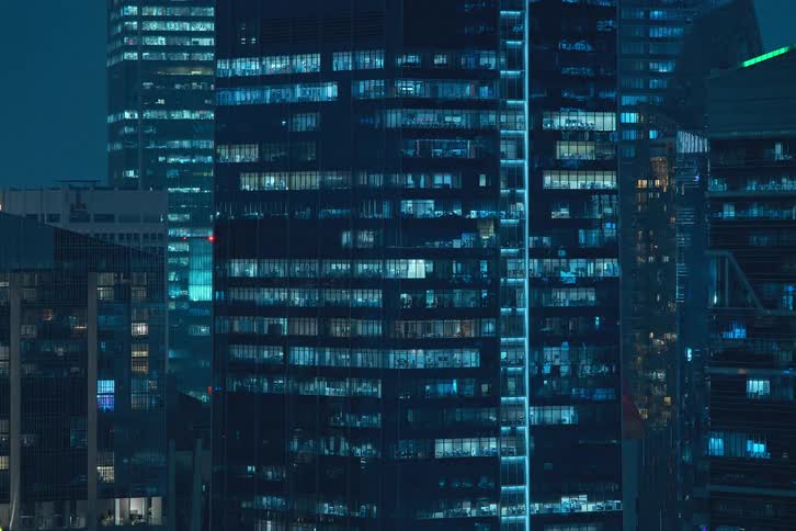 Panorama of residential buildings in a metropolis at night with lights in time lapse